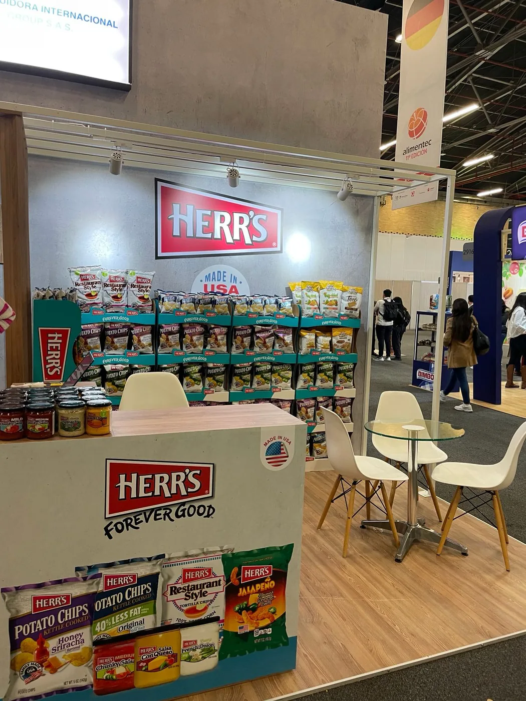 HERR'S stand at the Alimentec trade show, with product displays and a seating table